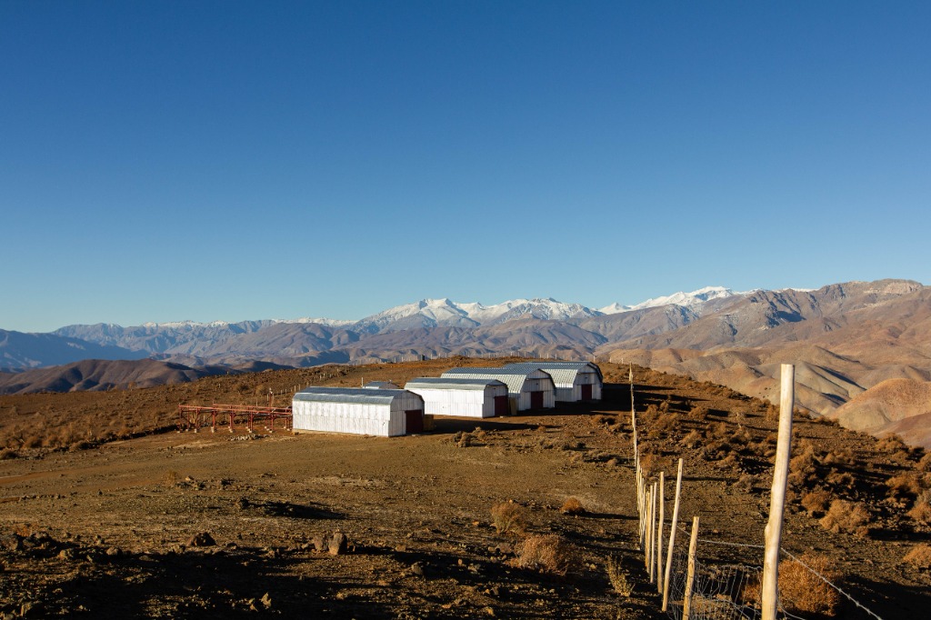 Observatories in the desert with mountains in the background